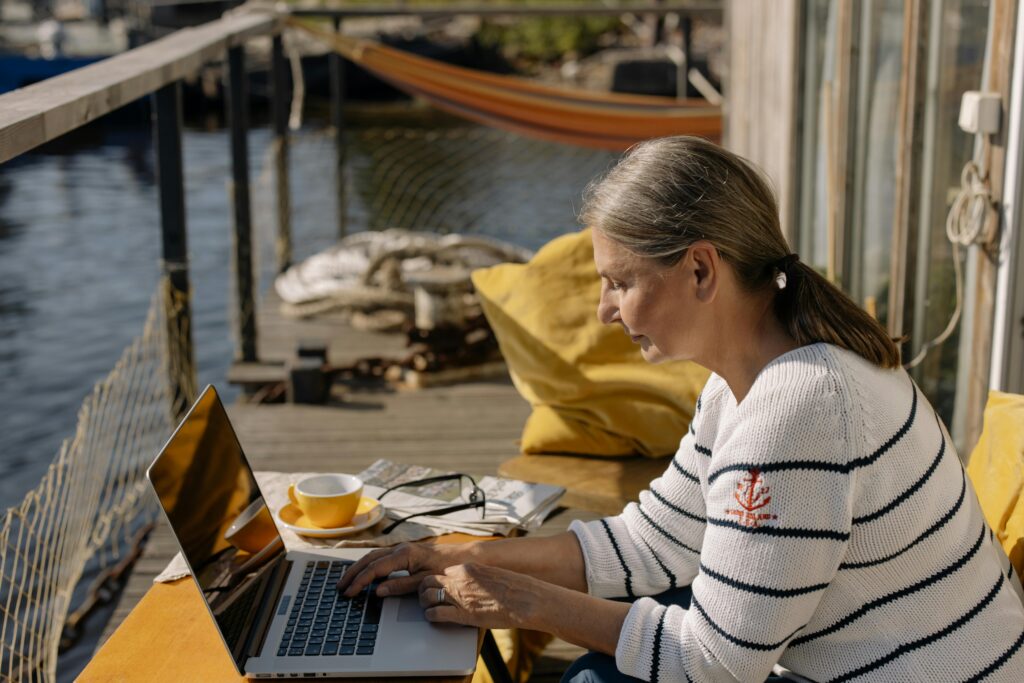 “Retiree working on laptop doing affiliate marketing from home”